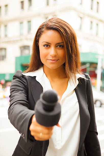 istock Female reporter with a microphone 176649990