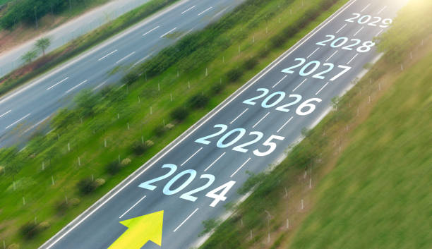 Empty asphalt road with new year numbers 2024, 2025 to 2029 stock photo