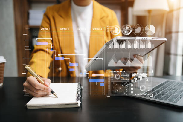 istock Businessman hand Project manager working and update tasks and Gantt chart scheduling virtual diagram.with smart phone, tablet and laptop 1766523123