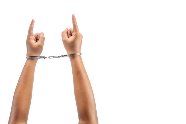 istock Human hand in handcuff with a hand gesture of pointing something 1766525835