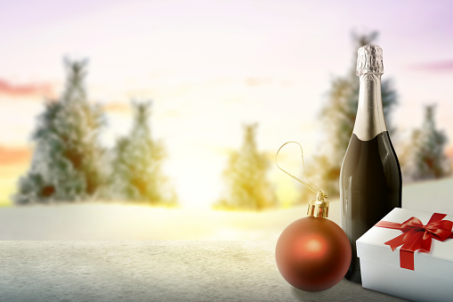 Christmas ornament with beverage and gift box on a snowy field. Christmas background concept