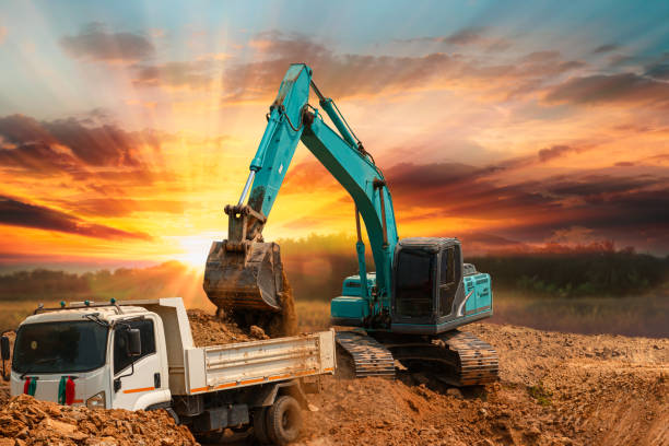 istock Crawler Excavator digging the soil into a truck ,In the construction site  . 1766536267