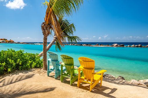 istock Beautiful Coloured Chairs On A Caribbean Beach 1766537313