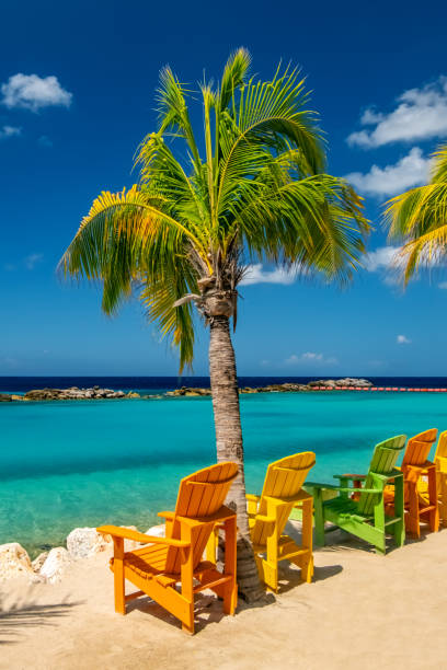 Two colorful beach chairs on Seven miles beach in Grand Cayman