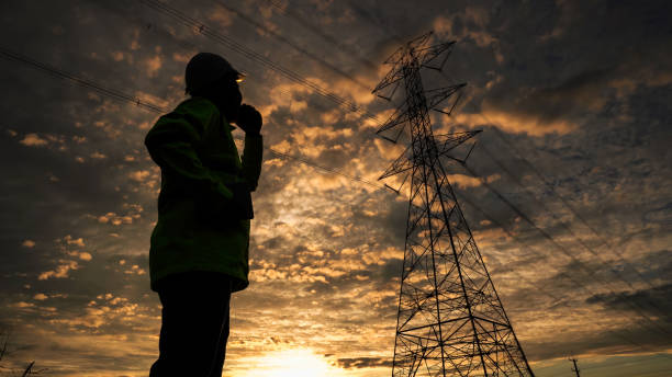 istock Silhouette of engineer man checking high-voltage power lines. 1766572759