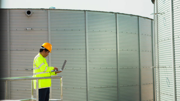 istock Asian male engineer check quality road work Large plumbing tank at construction site. 1766573980