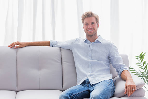 istock Man sat on a couch in the living room 176657864