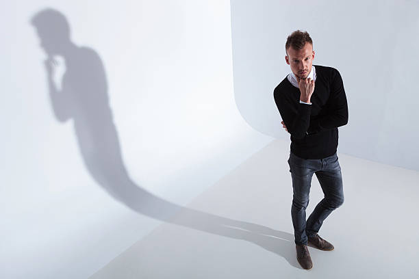 istock casual man looks up at you pensively 176658162