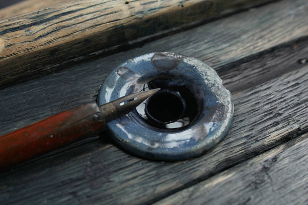 Old fashioned inkwell and pen Close up of an old fashioned desk inkwell and ink pen inkpen stock pictures, royalty-free photos & images