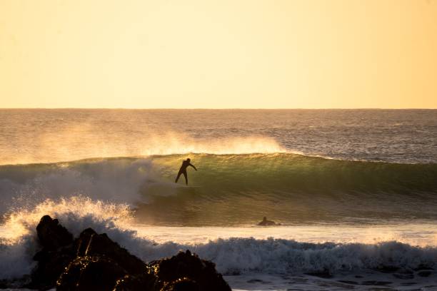 istock Surfer navigating a large wave in the ocean at sunset on a beautiful, clear day in Punta de Lobos 1766590682