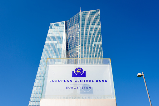Frankfurt am Main, Germany - August 20, 2023: Low angle view of the sign and logo of the European Central Bank at the southern entrance of the Skytower building, headquarters of the ECB since 2015.