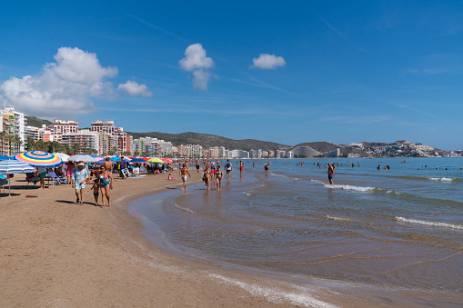Tourists and visitors enjoying the beach and Mediterranean sea in the beautiful coast town of Cullera, Valencian Community, Spain on Saturday 9th September 2023