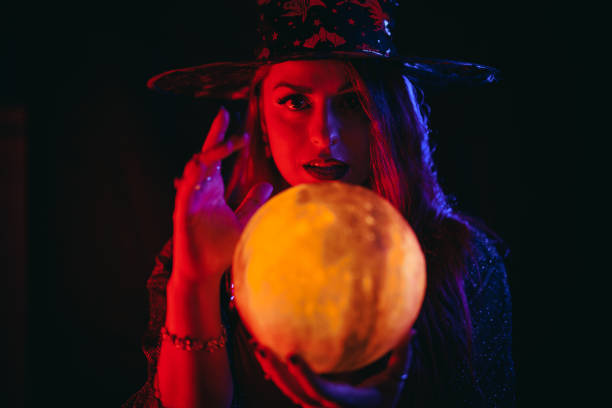 istock Young Woman Dressed Like A Witch Holding A Crystal Ball 1766614933