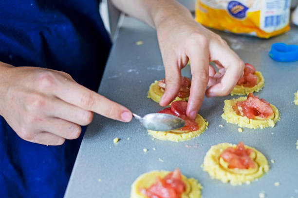 istock girl puts apple jam on shortbread cookies with her hands 1766615469