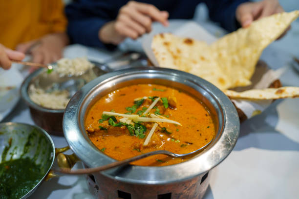 istock A table set with Indian food, including naan, biryani, chicken curry, and various sauces. 1766617672