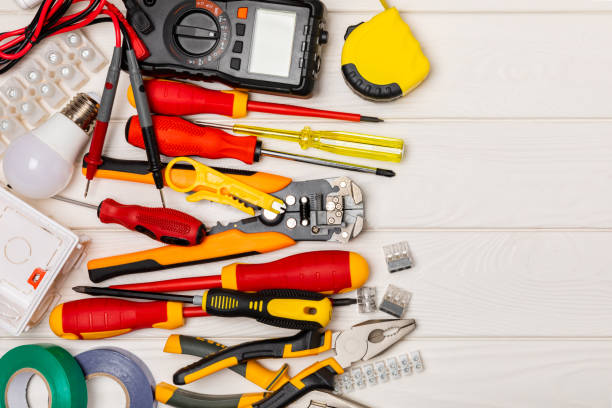 istock Electrician tools on background. Multimeter,construction tape,electrical tape, screwdrivers,pliers,an automatic insulation stripper, socket and LED lamp. Flatley. electrician concept. 1766622741