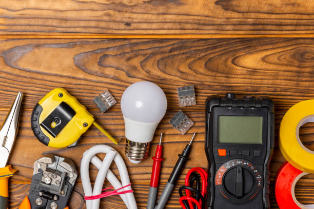 istock Electrician tools on background. Multimeter,construction tape,electrical tape, screwdrivers,pliers,an automatic insulation stripper, socket and LED lamp. Flatley. electrician concept. 1766622757