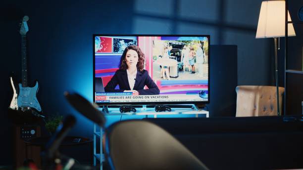 istock TV news broadcast in dimly lit apartment 1766627111