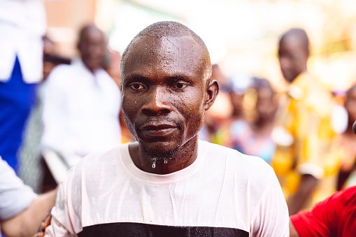 abidjan, Ivory Coast – February 26, 2023: A man during a religious baptism ritual in Abidjan, Cote d'Ivoire