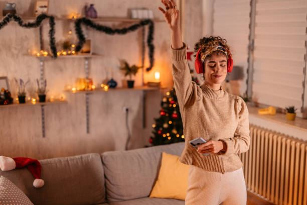 istock Young Woman Singing And Dancing At Home At Christmas 1766653155