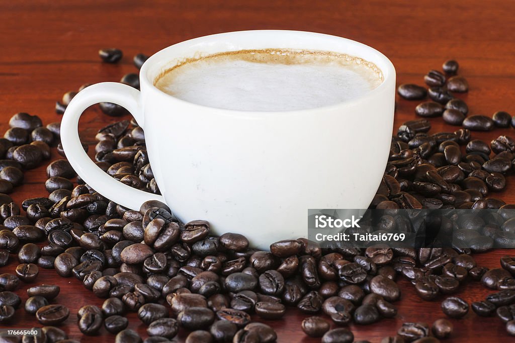 Coffee cup and seed Coffee cup and seed on wood table Backgrounds Stock Photo