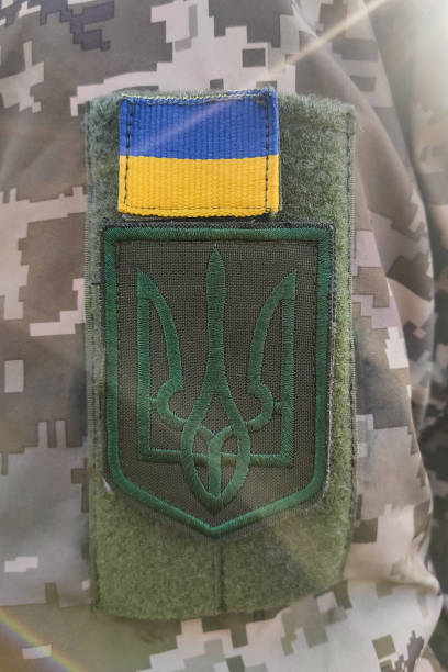 istock Close-up texture pixel camouflage military uniform of the Armed Forces, chevron trident and flag of Ukraine 1766697883