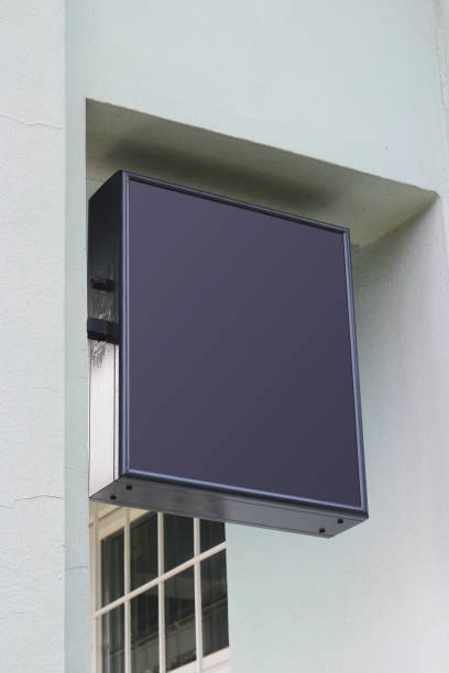 istock Mounted square sign on a wall with urban brick environment for advertising mockup. Template for logo, branding and corporate identity of shop, cafe, restaurant. 1766707900