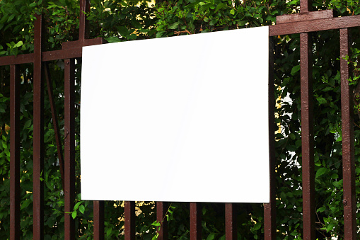 Blank billboard sign mockup on a fence in the urban environment, empty space to display advertising campaign mock up template.