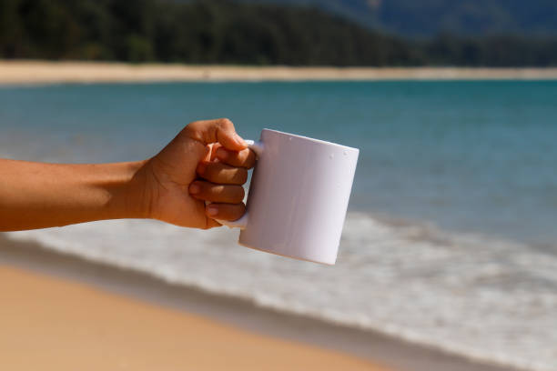 istock A white mug placed on a log with a view of nature in the background. 1766715659