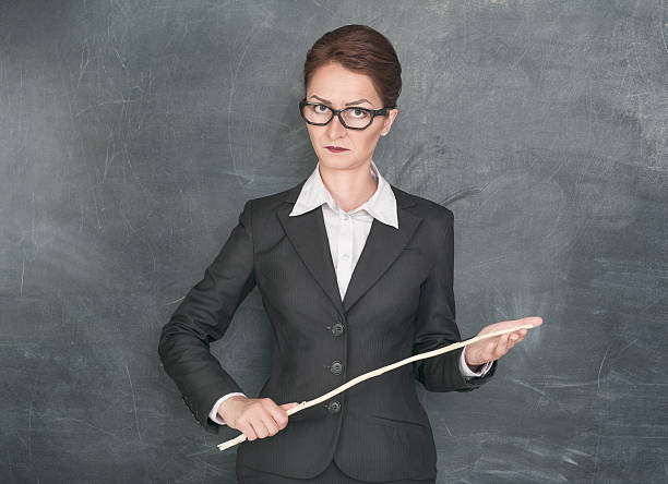 Strict teacher with wooden stick stock photo