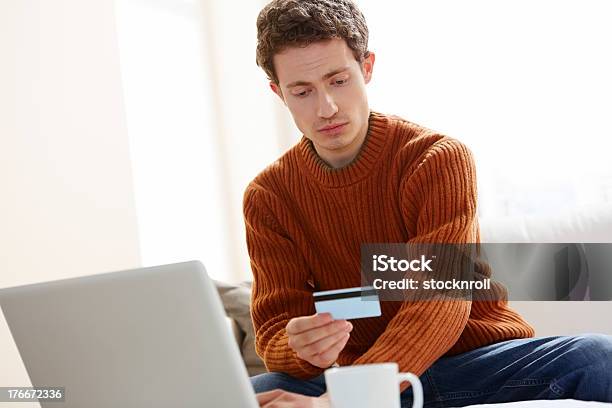 Young Man Making Online Payments With Credit Card Stock Photo - Download Image Now - 20-24 Years, Adult, Adults Only