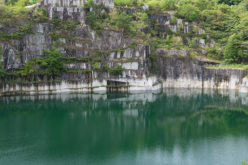 A lake filled with water at the site of a granite quarry