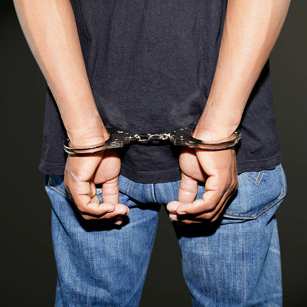 istock Close up of handcuffed hands 176673981