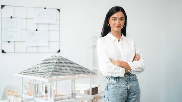 istock Young beautiful architect poses confidently with house model. Immaculate. 1766759137