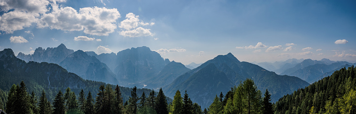 Wide panoramic composition with view on the beautiful natural mountain environment in north-eastern Friuli Venezia Giulia, near Tarvisio, under the sunlight, in a summer day