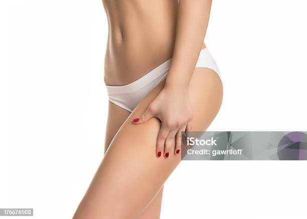 Female Squeezing Skin On Her Legs And Showing No Cellulite Stock Photo - Download Image Now