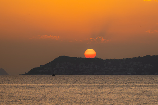 Sun is setting over by horizon.\nLocation : Istanbul - Turkey.