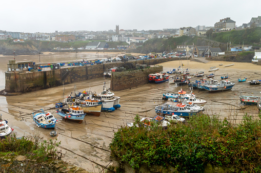 St. Michael's Mount. Cornwall. UK- 19.02.2023. View of the harbour at low tide with boats on the beach.