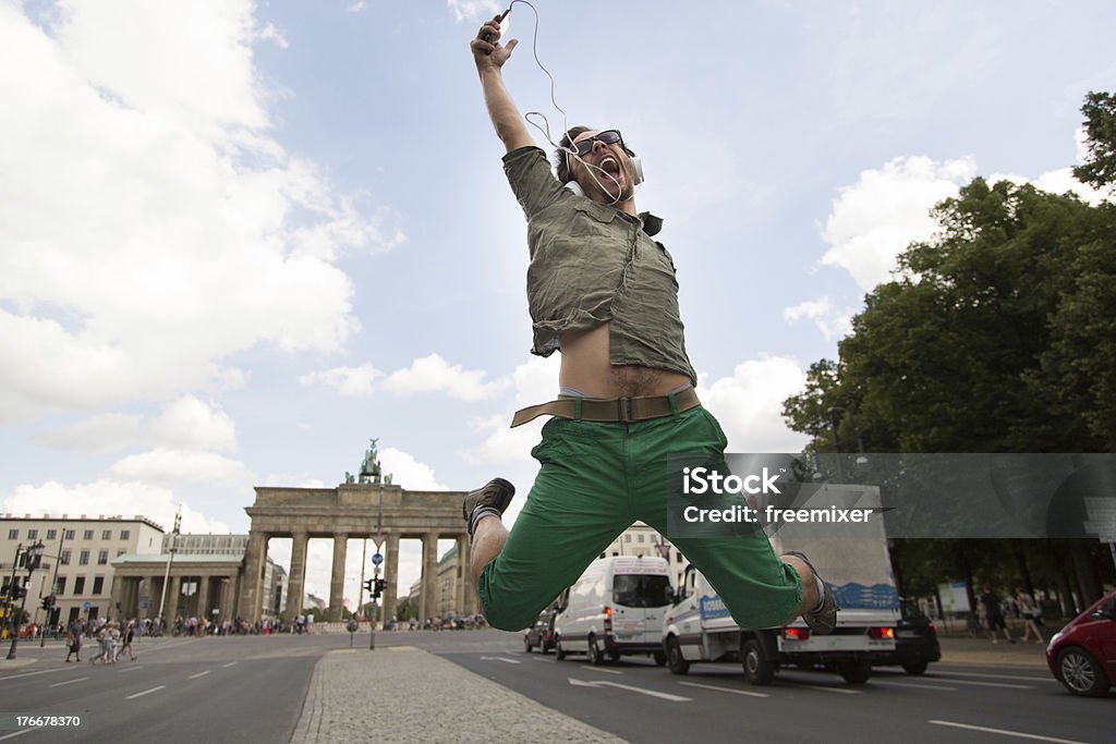 Young man in front of Brandenburg gate Young man jumping on the street in front of Brandenburg gate 20-24 Years Stock Photo