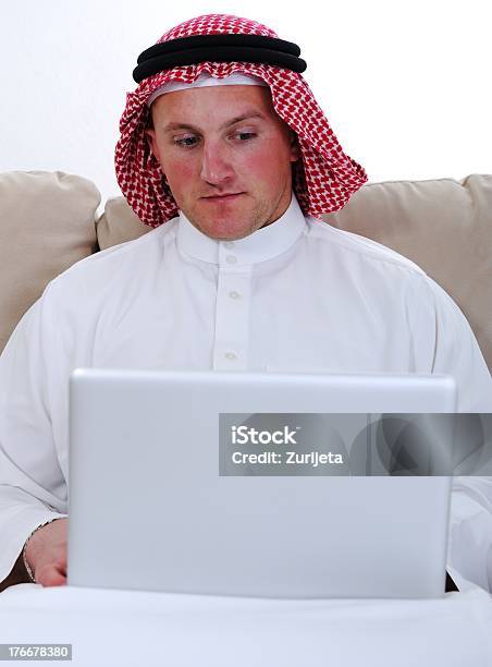 Arabic Man Using Laptop At Home Stock Photo - Download Image Now - Adult, Adults Only, Arabic Style