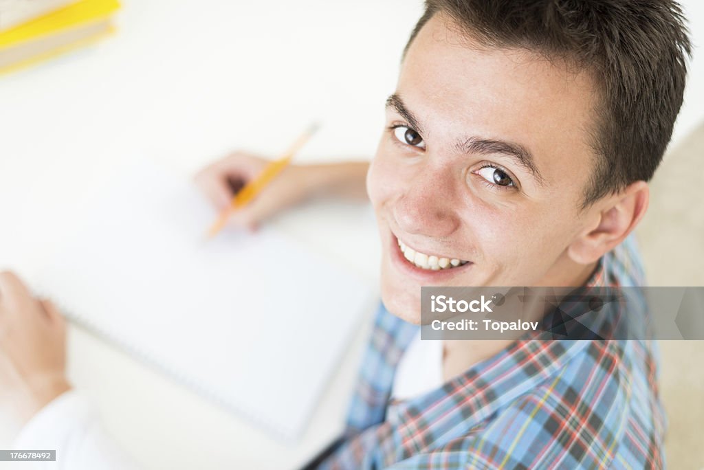 Happy student Happy student doing his homework 18-19 Years Stock Photo