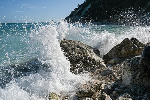 A splashing wave on the rocky coast