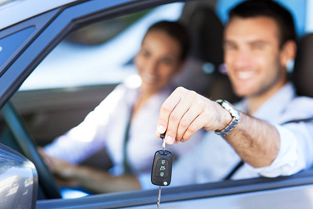 istock Young couple with keys to new car 176678820