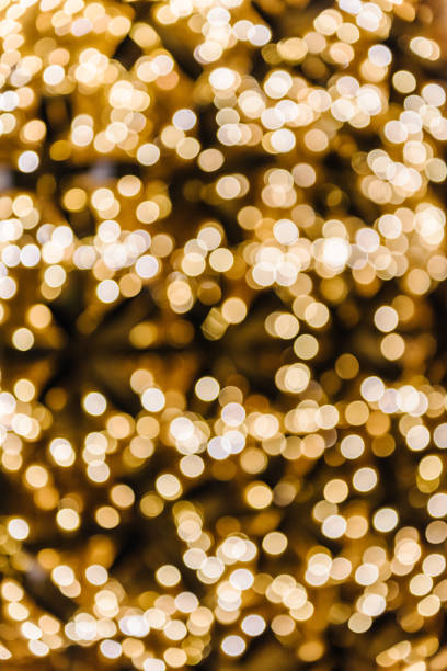 istock Yellow abstract blur bokeh made from Christmas light on black isolated background. Bokeh lights. Greeting card. Happy New Year 2024. Beautiful holiday billboard or festive glowing golden wall. Closeup 1766792127
