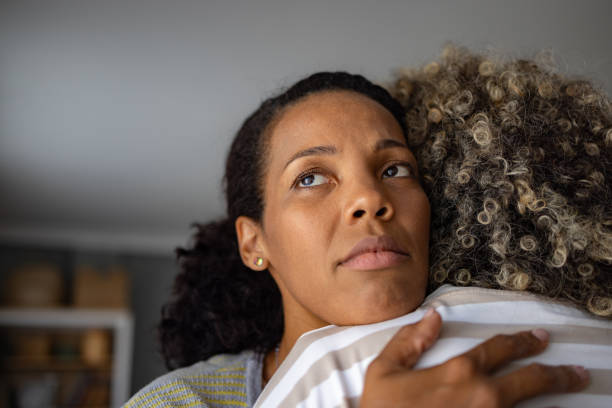 istock Sad black daughter embracing her mother at home. 1766803076