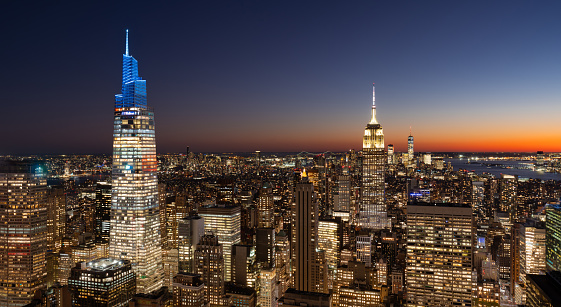 New York skyline of Midtown skyscrapers at twilight. The cityscape view extends all the way to Lower Manhattan