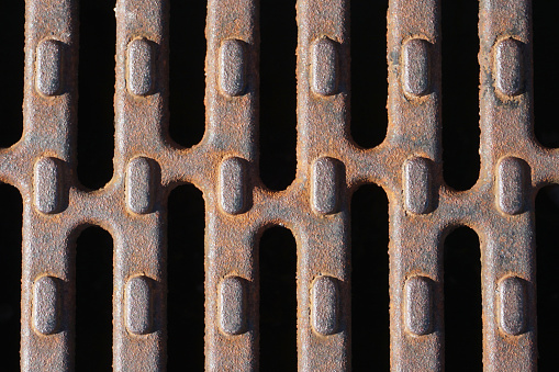 Photograph of rusty metal treads.
