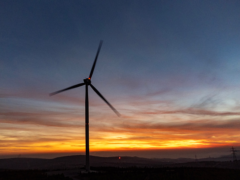 Beautiful sunset above the wind turbine