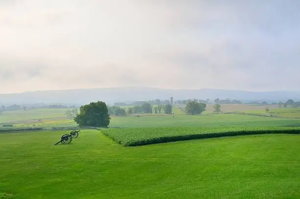 The rolling hills of the Antietam National Battlefield look mach as they did when the bloodiest day of American history occurred here during the American Civil War. Canons accent the fields and an observation tower is in the background along with several war memorials erected in honor of those who fought and died here.