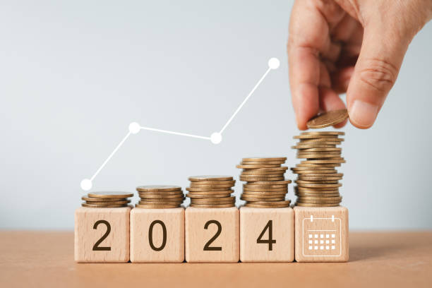 istock 2024 text on wooden cube block with hand arranging stack of coin and increasing graph for planning, investment, savings , business strategy concept 1766811423